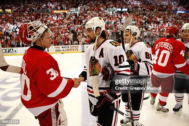 Goalie Chris Osgood of the Detroit Red Wings is congratulated by Patrick SHarp of the Chicago Blackhawks after the Red Wings won 2-1 in overtime...