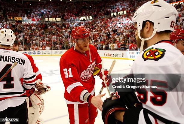 Marian Hossa of the Detroit Red Wings is congratulated Ben Eager of the Chicago Blackhawks after the Red Wings won 2-1 in overtime during Game Five...