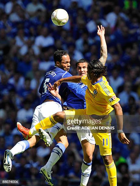 Everton's Joleon Lescott and Tim Cahill vie for the ball against Chelsea's Didier Drogba in the FA Cup final at Wembley, in north London,on May 30,...