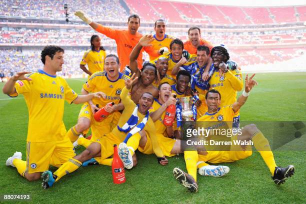 Chelsea players celebrate with the trophy after the FA Cup sponsored by E.ON Final match between Chelsea and Everton at Wembley Stadium on May 30,...