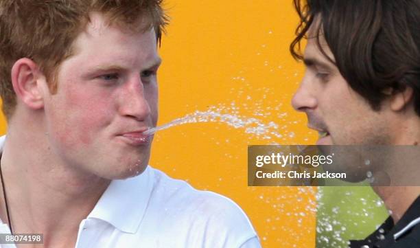 Prince Harry spits champagne at Nacho Figueras, captain of the Blackwatch team the Prince's Sentebale team triumphed in the 2009 Verve Clicquot...