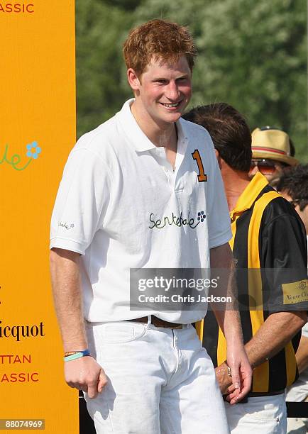 Prince Harry is sprayed with champagne by a Sentebale teammate after they triumphed over the Blackwatch team during the 2009 Verve Clicquot Manhattan...
