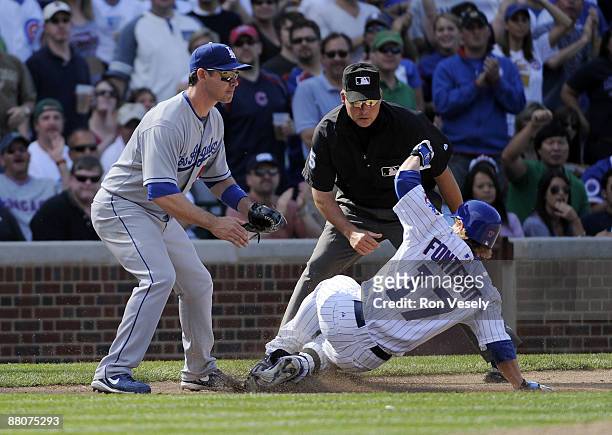 Mike Fontenot of the Chicago Cubs slides safely into third base with a triple in the fourth inning against the Los Angeles Dodgers on May 30, 2009 at...