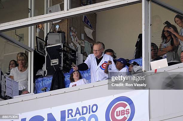 Talk show celebrity Larry King leads the fans through a version of "Take Me Out To The Ball Game" during the seventh inning of the game between the...