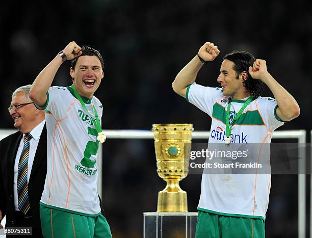 Sebastian Boenisch and Claudio Pizarro of Bremen celebrate after winning the DFB Cup Final match between Bayer Leverkusen and Werder Bremen at the...