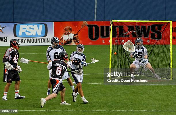 Brian Langtry of the Denver Outlaws follows through on his shot as he scores a first period goal on goalie Chris Garrity of the Washington Bayhawks...