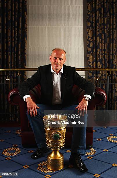 Coach Thomas Schaaf of Bremen poses for a photo with the DFB Cup Trophy during the Champions Dinner night at the Maritim Hotel after the DFB Cup...