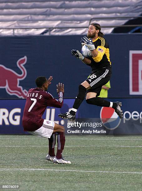 Goalkeeper Matt Pickens of the Colorado Rapids jumps high in the air to make as save as his teammate Cory Gibbs looks on during their game at Giants...