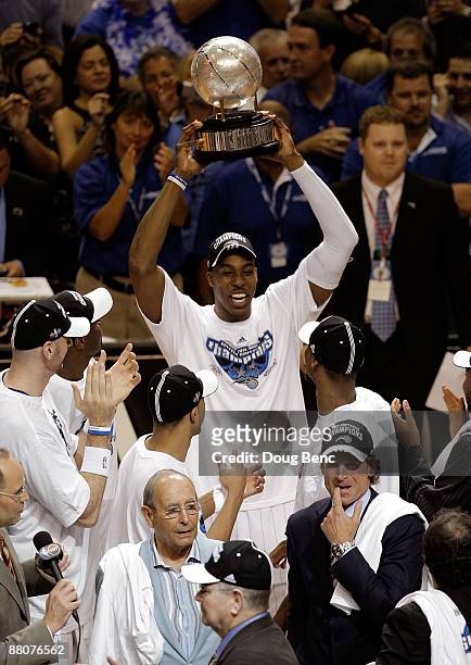 Dwight Howard of the Orlando Magic holds up the trophy after defeating the Cleveland Cavaliers in Game Six of the Eastern Conference Finals during...