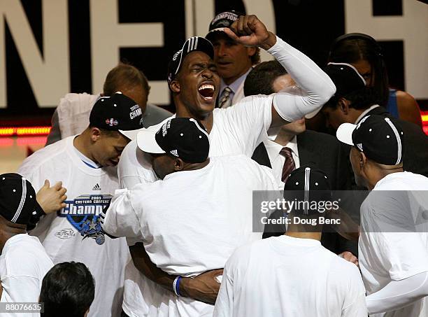 Dwight Howard of the Orlando Magic hugs teammate Anthony Johnson in celebration on the court after defeating the Cleveland Cavaliers in Game Six of...