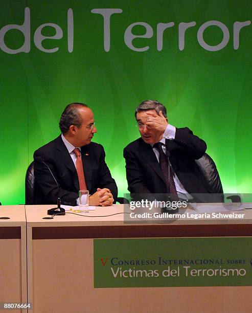 Mexican President Felipe Calderon talks with Colombia's President Alvaro Uribe during the closure of the 5th Terrorism Victims International Congress...