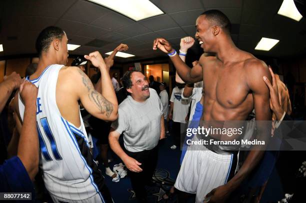 Courtney Lee, head coach Stan Van Gundy and Dwight Howard of the Orlando Magic celebrate after defeating the Cleveland Cavaliers 103-90 in Game Six...