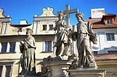 Statuary of Christ the Saviour with St. Cosmas and St. Damian on the Charles Bridge (Karluv Most) in Prague, Czech Republic