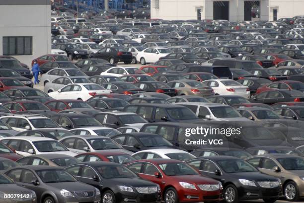 Newly produced cars are parked outside the warehouse of Shanghai General Motors Corp on May 29, 2009 in Shanghai, China. General Motors Corp....