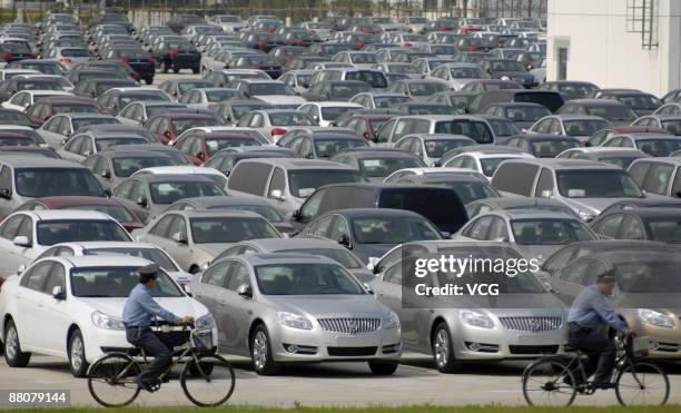 Newly produced cars are parked outside the warehouse of Shanghai General Motors Corp on May 29, 2009 in Shanghai, China. General Motors Corp....