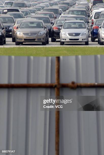 Newly produced cars are parked outside the warehouse of Shanghai General Motors Corp on May 29, 2009 in Shanghai, China. General Motors Corp....