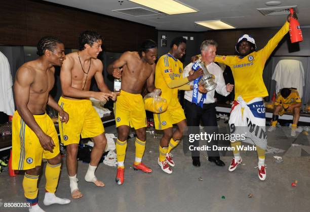 Chelsea Manager Guus Hiddink dances with Florent Malouda, Franco Di Santo, Didier Drogba, John Obi Mikel and Michael Essien of Chelsea in the...