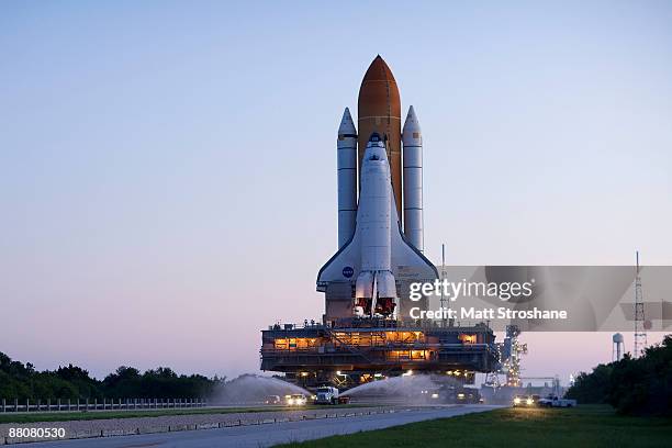 Space Shuttle Endeavour rolls atop the crawler transporter from launch pad 39-b to launch pad 39-a at Kennedy Space Center on May 31, 2009 in Cape...