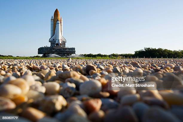 Space Shuttle Endeavour rolls atop the crawler transporter from launch pad 39-b to launch pad 39-a at Kennedy Space Center in Cape Canaveral,...