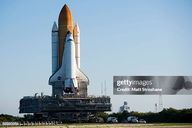 Space Shuttle Endeavour rolls atop the crawler transporter from launch pad 39-b to launch pad 39-a at Kennedy Space Center in Cape Canaveral,...