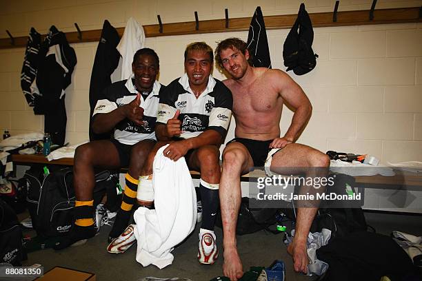 Serge Betsen Tchoua, Jerry Collins and Rocky Elsom of the Barbarians celebrate in their changing room following their victory in the match between...