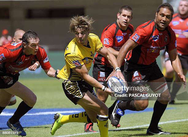Albi's Benjamin Lapeyre tries to pass the ball despite Oyonnax's Adrien N'Goma and Frederic Charrier during the French Pro D2 rugby union final...