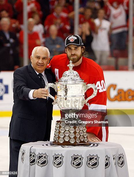 Henrik Zetterberg of the Detroit Red Wings recieves the Clarence S. Campbell Bowl from NHL Senior Vice President of Hockey Operations Jim Gregory...