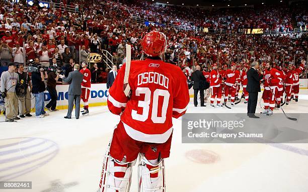 Chris Osgood of the Detroit Red Wings skates towards his teammates as they celebrate their 2-1 overtime win against the Chicago Blackhawks during...