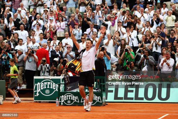 Robin Soderling of Sweden salutes the fans following his victory during the Men's Singles Fourth Round match against reigning champion Rafael Nadal...