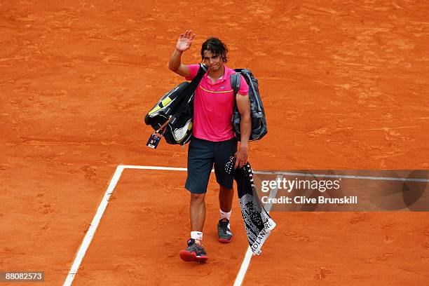 Defeated champion Rafael Nadal of Spain waves to the crowd as he walks off court following his defeat during the Men's Singles Fourth Round match...