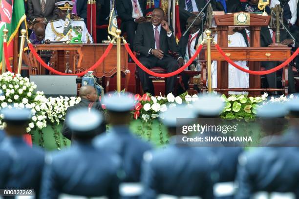 Newly re-elected Kenyan President Uhuru Kenyatta smiles during his swearing in ceremony at Kasarani Stadium on November 28, 2017 in Nairobi. Kenyatta...