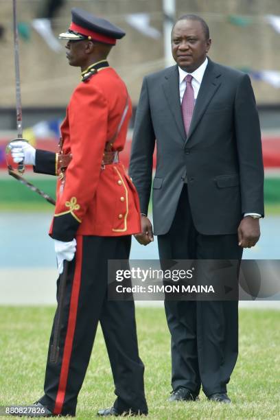 Newly re-elected Kenyan President Uhuru Kenyatta reviews a guard of honour during his swearing in ceremony at Kasarani Stadium on November 28, 2017...