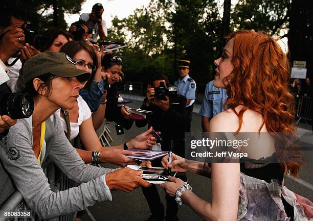 Actress Rose McGowan signs autographs as she arrives at amfAR's Cinema Against AIDS 2008 benefit held at Le Moulin de Mougins during the 61st...