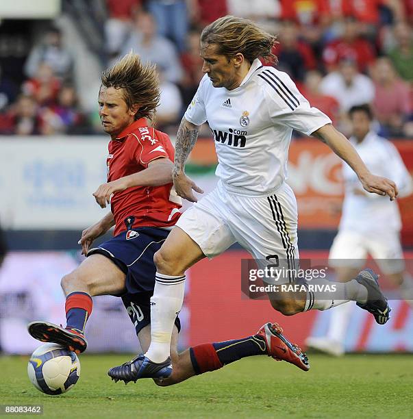 Osasuna's Plasil is tackled by Real Madrid's Michel Salgado during a Spanish league football match, on May 31 at Reyno de Navarra stadium in...