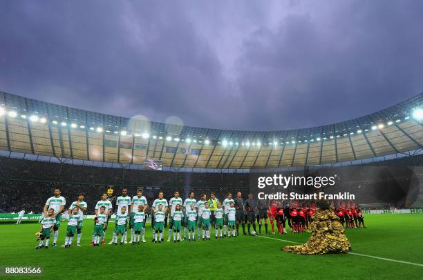 The teams of Bremen and Leverkusen line up at the start of the DFB Cup Final match between Bayer 04 Leverkusen and SV Werder Bremen at Olympic...