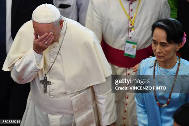 Pope Francis gestures beside Myanmar's civilian leader Aung San Suu Kyi in Naypyidaw on November 28, 2017. Pope Francis held talks with Myanmar's...