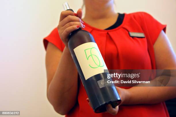 Hostess serves Adega da Cartuxa winery's "DOC Alentejo - Evora Branco 2012 - 50 Anos" white wine during a tasting at the winery on September 30, 2016...