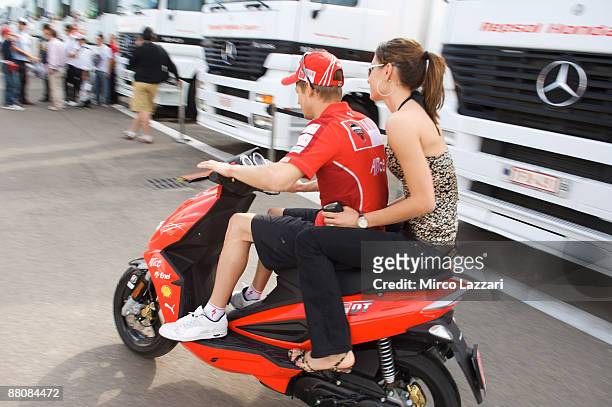 Casey Stoner and Adriana Stoner of Australia and Ducati Malboro Team ride a scooter in paddock before MotoGp race in Mugello Circuit on May 31, 2009...