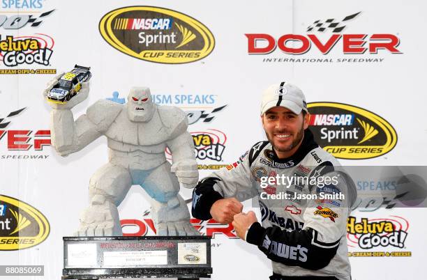 Jimmie Johnson, driver of the Lowe's Chevrolet, poses in victory lane after winning the NASCAR Sprint Cup Series Autism Speaks 400 at Dover...