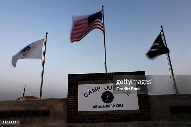 Flags wave above the sign posted at the entrance to Camp Justice, the site of the U.S. War crimes tribunal compound on May 31, 2009 at U.S. Naval...