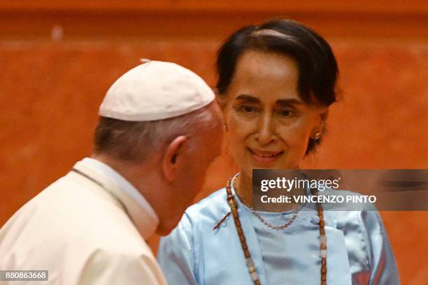 Myanmar's civilian leader Aung San Suu Kyi looks at Pope Francis during an event in Naypyidaw on November 28, 2017. - Pope Francis held talks with...