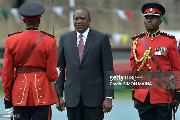 Newly re-elected Kenyan President Uhuru Kenyatta reviews a guard of honour during his inauguration ceremony for a second term at Kasarani Stadium on...