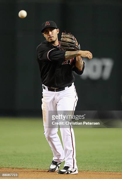 Infielder Felipe Lopez of the Arizona Diamondbacks fields a ground ball out against the Atlanta Braves during the major league baseball game at Chase...