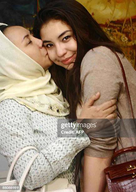 Manohara Odelia Pinot is kissed by her mother as she arrives at her residence in Jakarta on May 31, 2009. The teenage US-Indonesian model has...