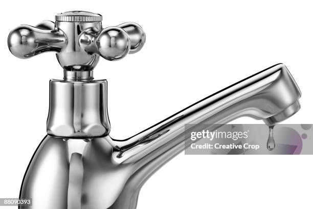 chrome tap / faucet with water dripping from it - cromo foto e immagini stock