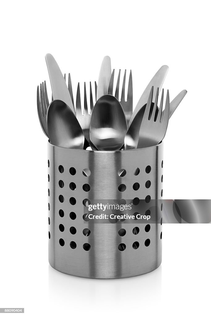 Stainless steel container containing knife, forks 