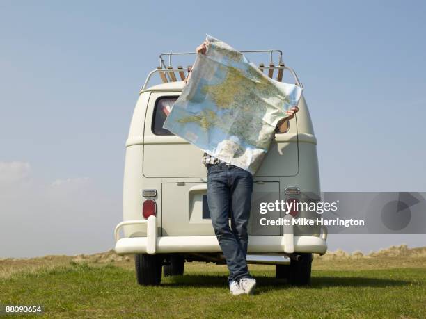 male with map outside camper van - camping stock pictures, royalty-free photos & images