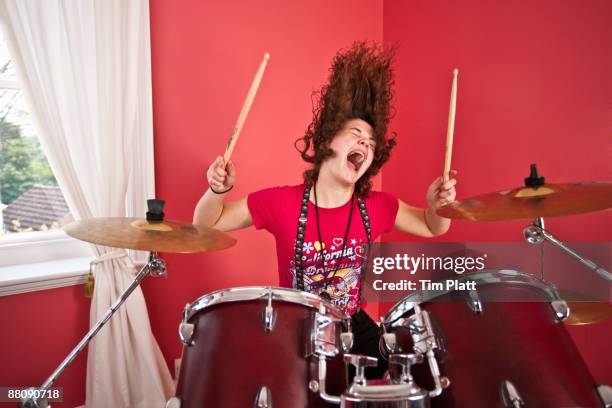 young girl playing drums - drums stock-fotos und bilder