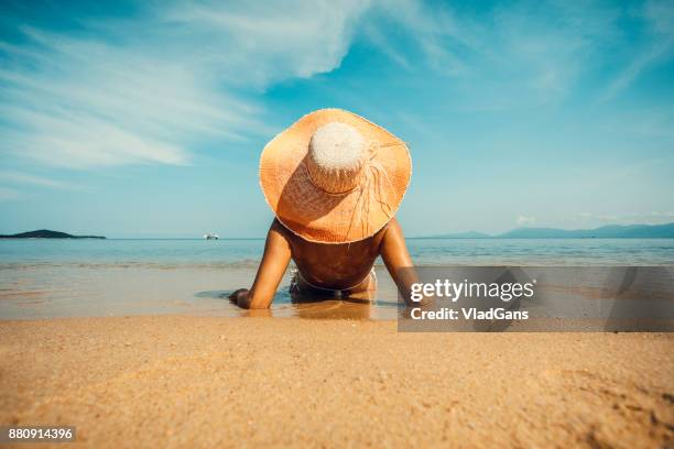 woman at tropical beach - beige hat stock pictures, royalty-free photos & images