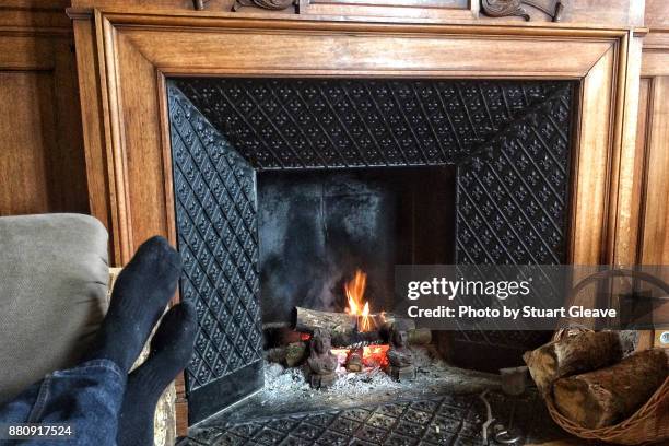 feet in front of fireplace - warming up stock pictures, royalty-free photos & images